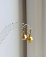 Mirror-luster South Sea pearl earrings with warm deep gold coloring.