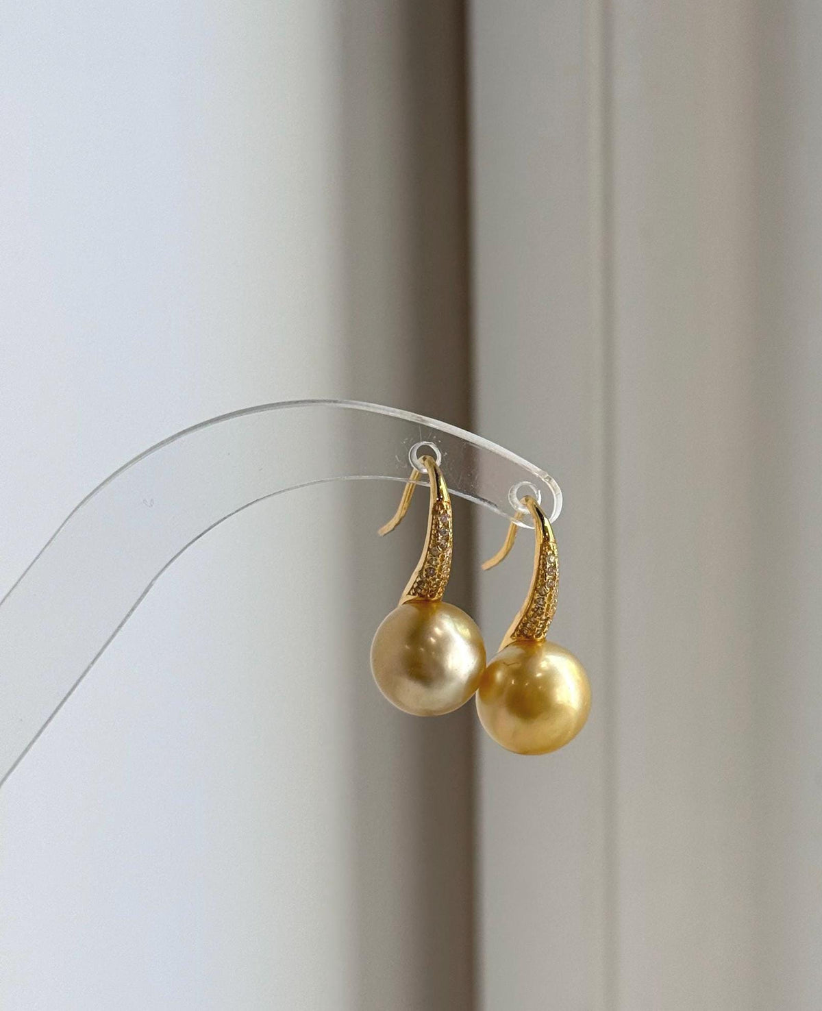Mirror-luster South Sea pearl earrings with warm deep gold coloring.