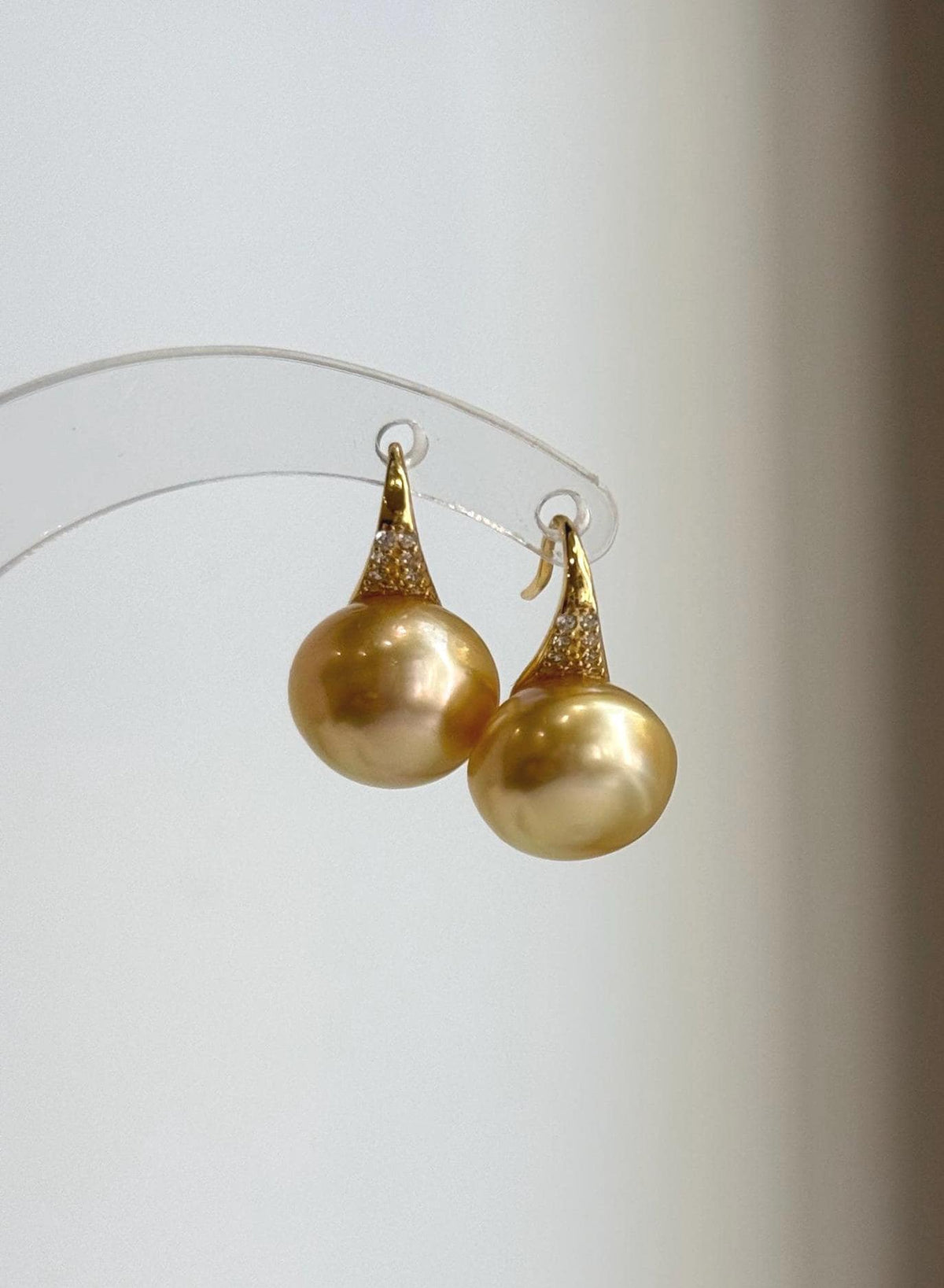 South Sea pearl drop earrings featuring rich golden tones and sterling silver settings.