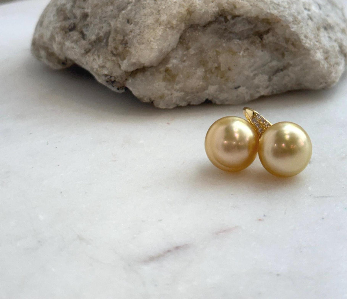 South Sea pearl drop earrings showcasing rich golden color and mirror-like reflections.