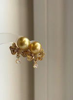 Genuine golden saltwater pearl earrings with mirror luster and sterling silver settings.