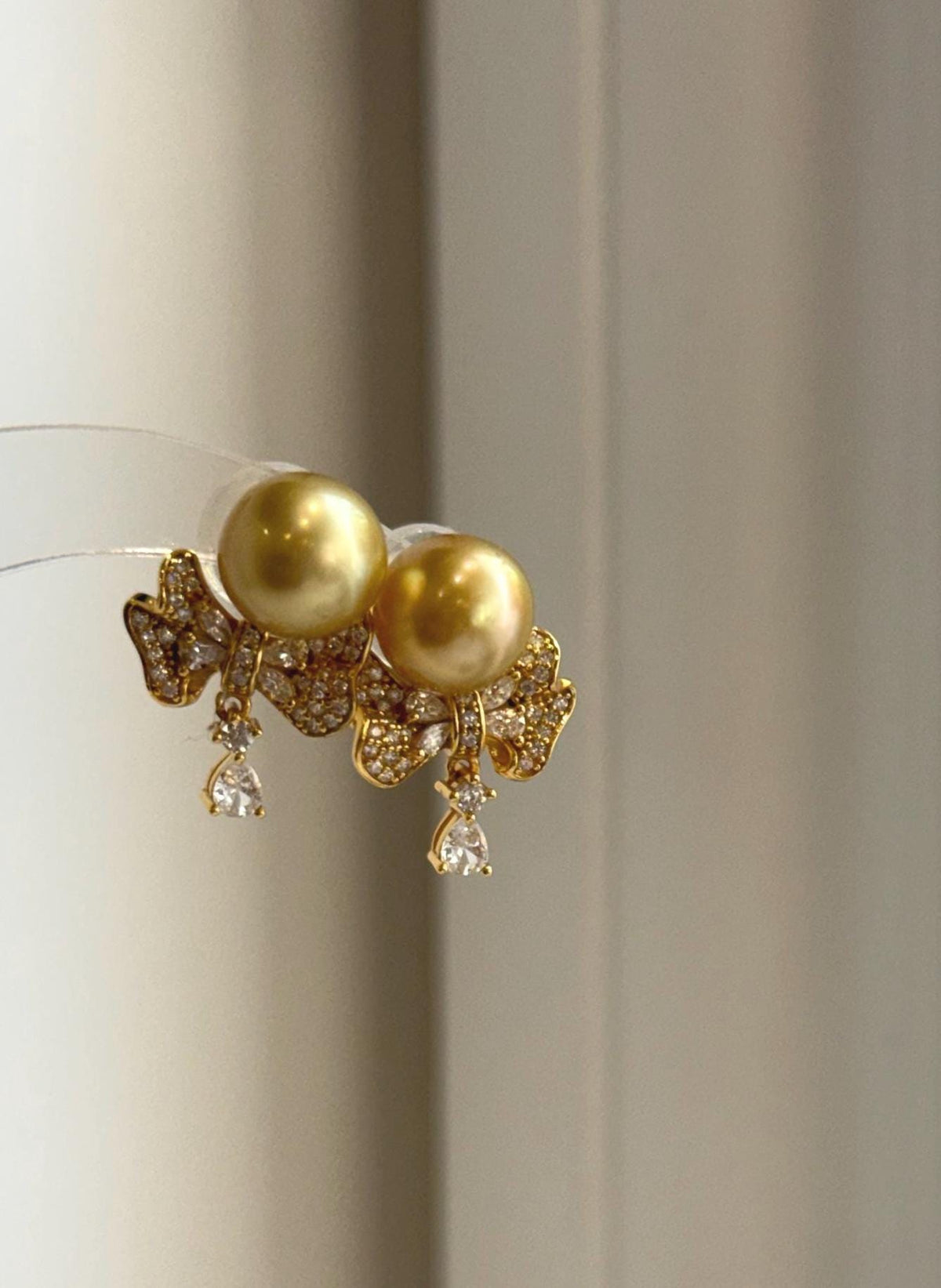 Genuine golden saltwater pearl earrings with mirror luster and sterling silver settings.