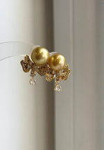 Golden South Sea pearls paired with sterling silver earring jackets.
