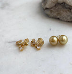 Tea golden saltwater pearl studs with lustrous surfaces and silver settings.