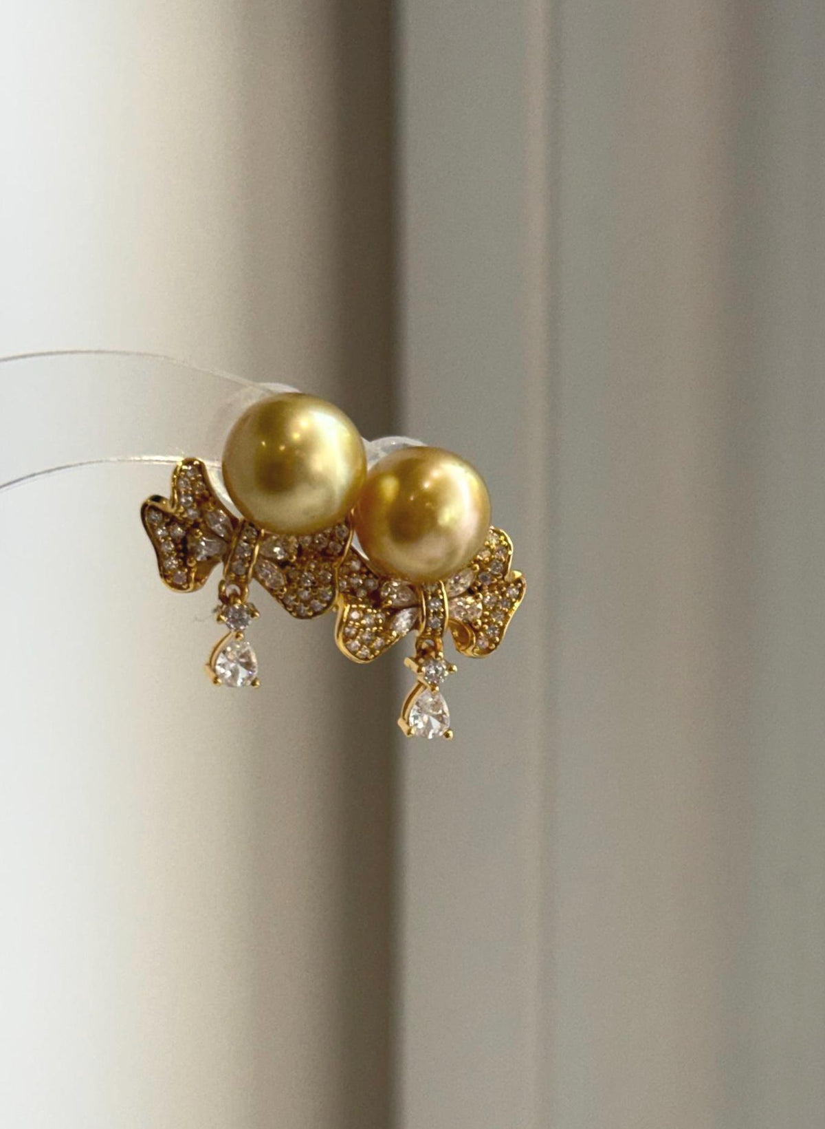 Genuine South Sea pearl studs with mirror luster and silver earring jackets.