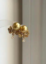Genuine South Sea pearl studs with mirror luster and silver earring jackets.