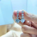 S925 sterling silver earrings with round brilliant-cut moissanite stones.