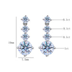 Minimalist sterling silver earrings featuring round moissanite stones with brilliant sparkle.