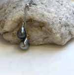 Two genuine Tahitian saltwater pearls featured in a sterling silver pendant necklace.