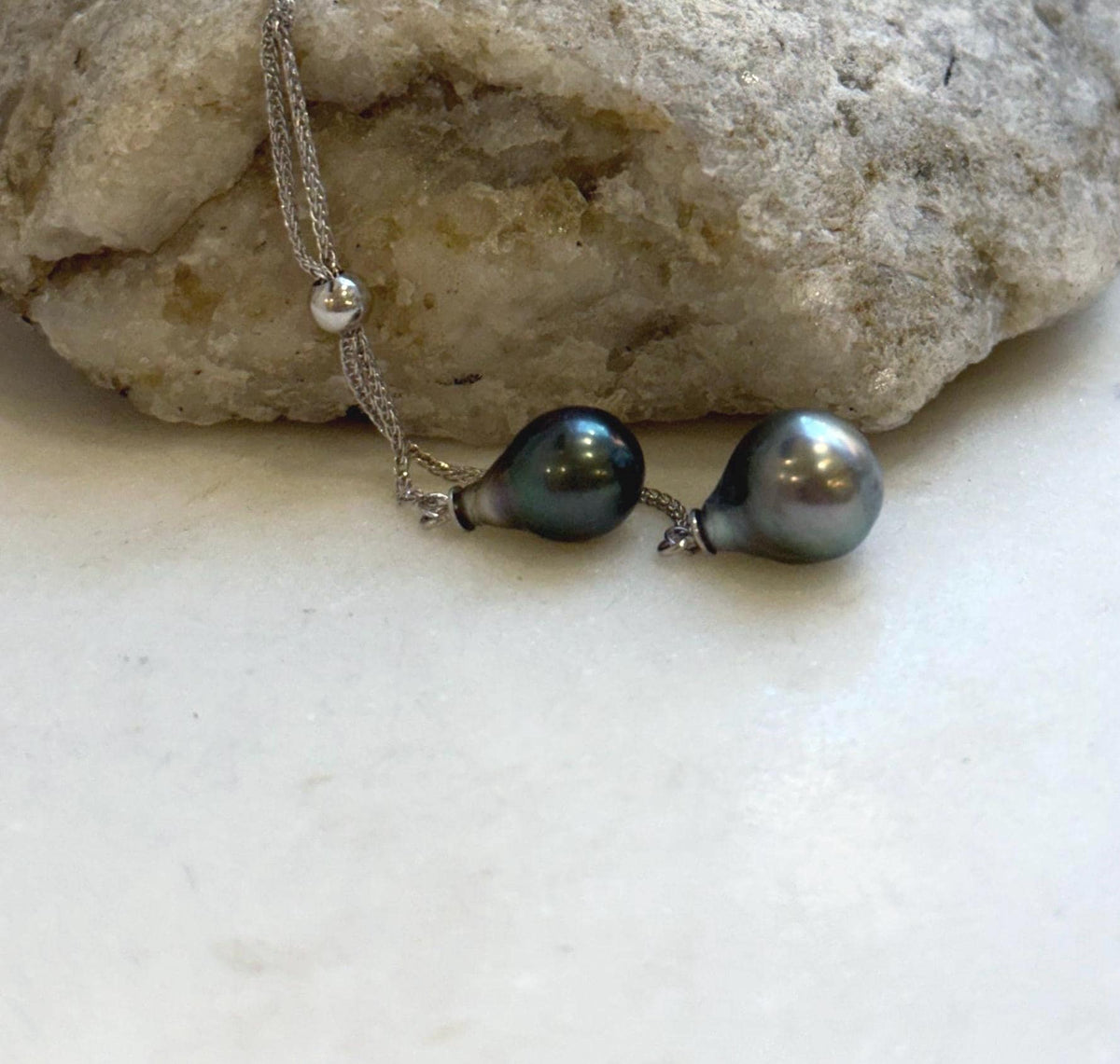 Lustrous double Tahitian pearl pendant suspended from a sterling silver chain.