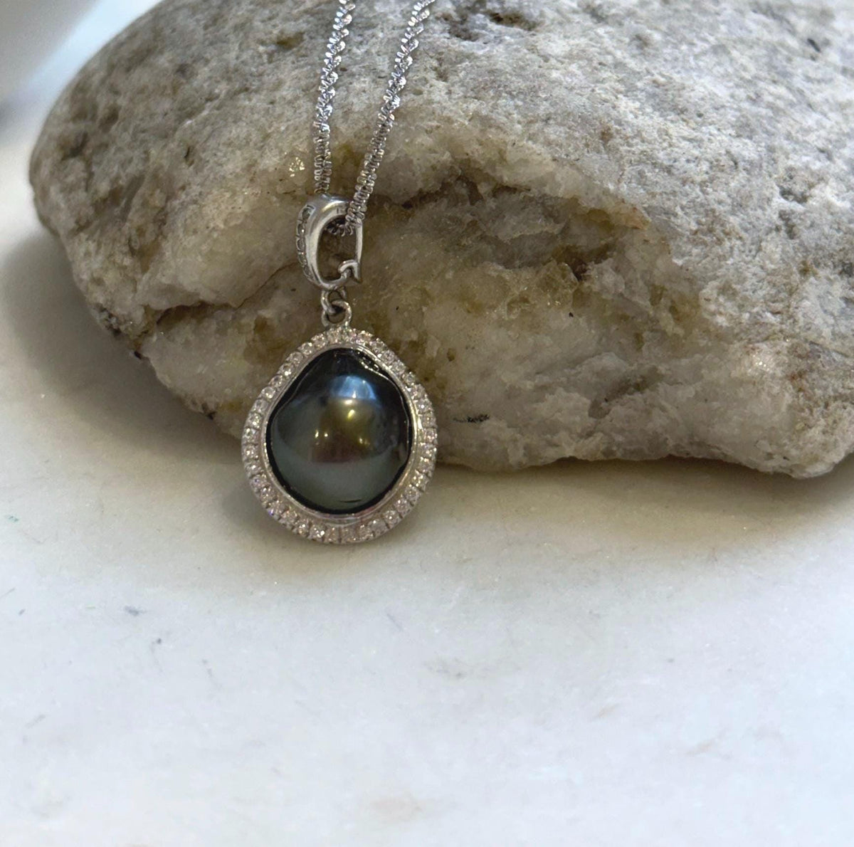 Tahitian saltwater keshi pearl necklace with a reflective surface and bronze overtones.