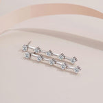 S925 sterling silver dangle earrings featuring five spaced round moissanite stones on each side.