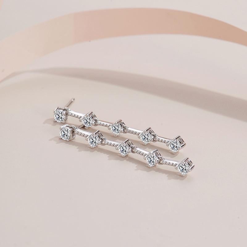 S925 sterling silver dangle earrings featuring five spaced round moissanite stones on each side.
