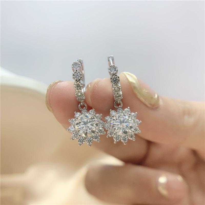 S925 sterling silver earrings featuring stone-set hoops and floral moissanite drops.