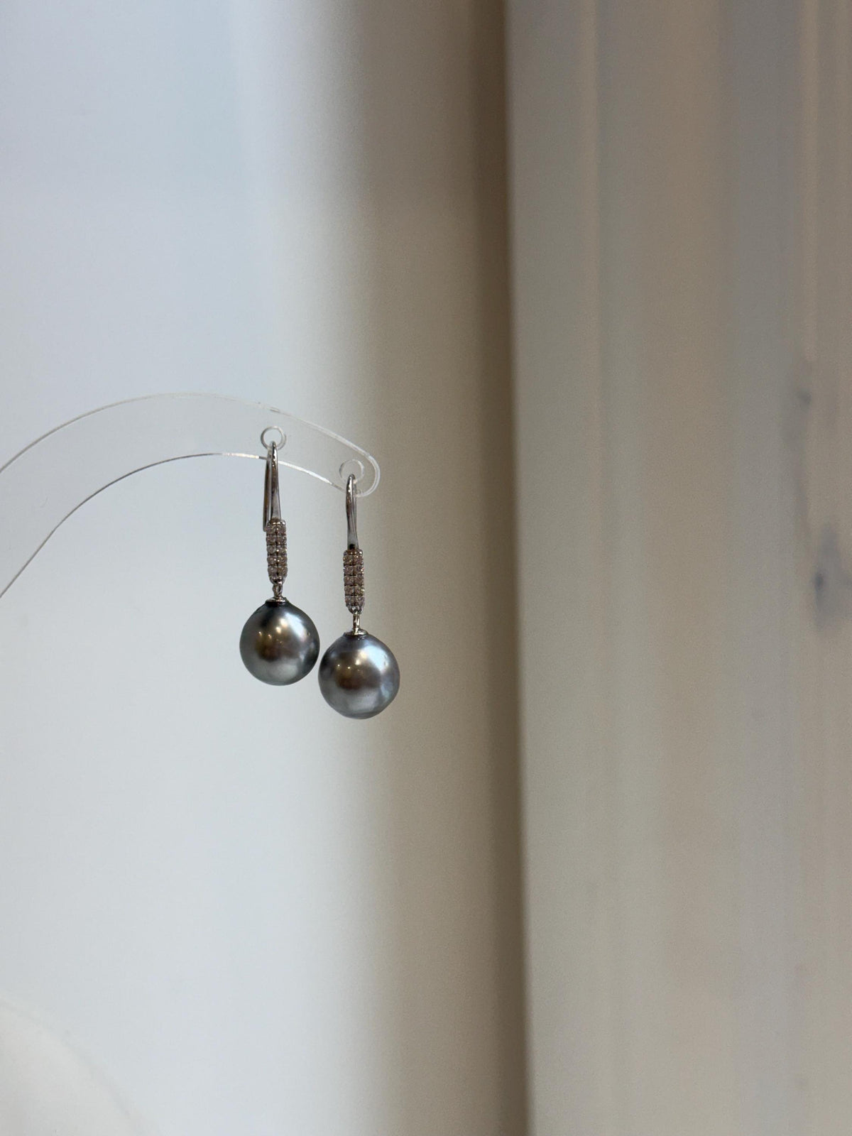 Silver hook earrings featuring dark gray pearls