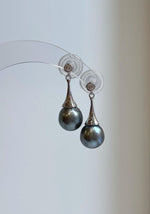 Round platinum gray pearls on curved silver hooks