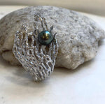 Two-in-one brooch and pendant featuring a peacock green Tahitian pearl.