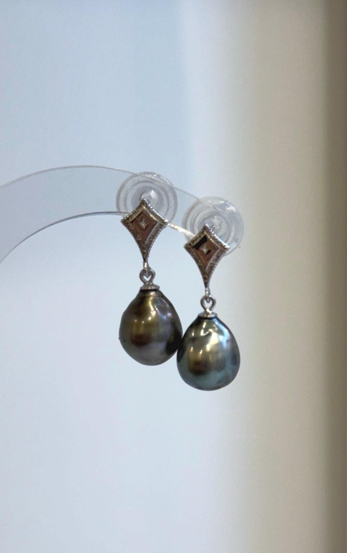 S925 sterling silver earrings featuring dark saltwater pearls and angular stud tops.