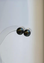 Tahitian pearl drop earrings with deep green tones and diamond-shaped silver tops.