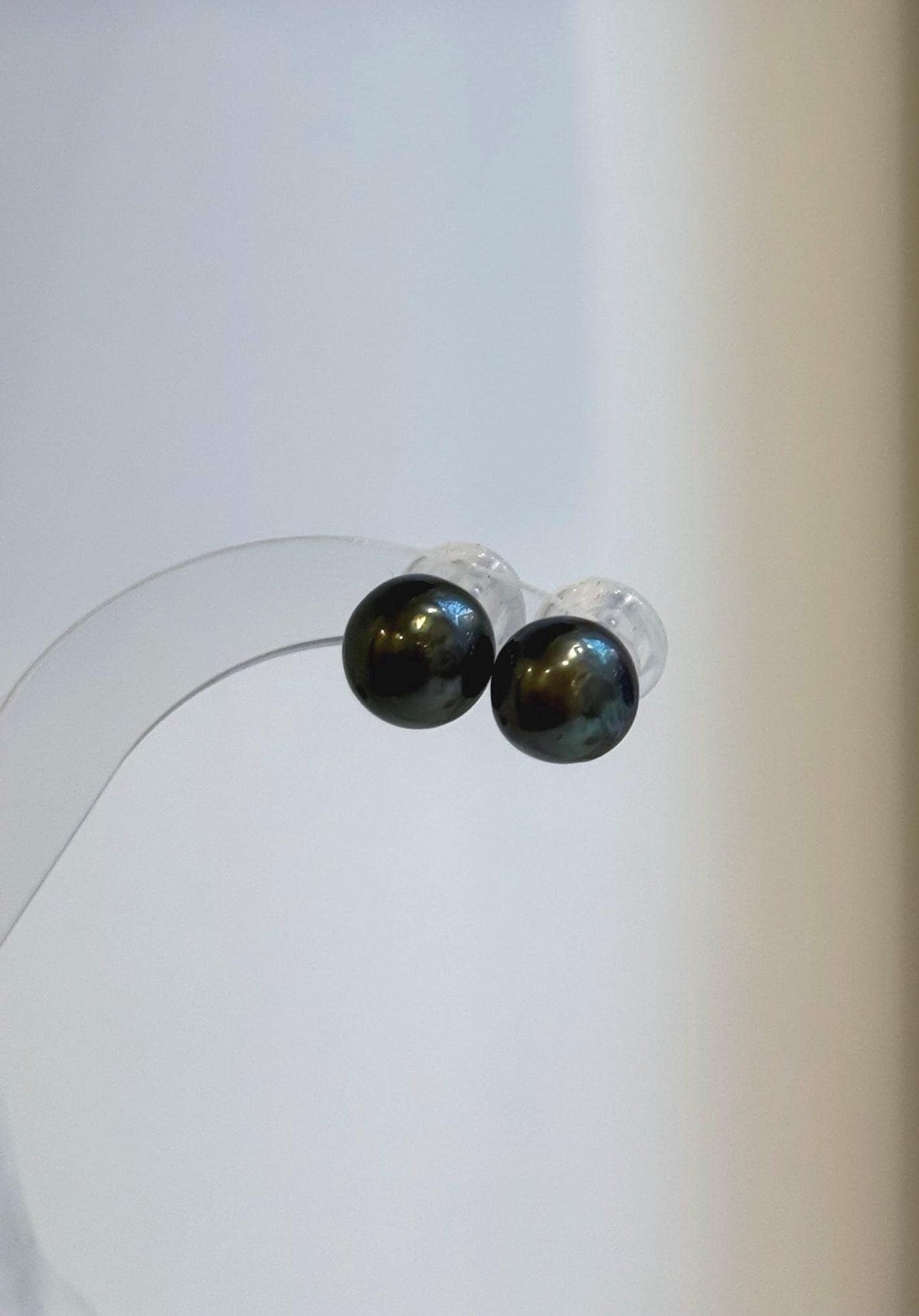 Tahitian pearl drop earrings with deep green tones and diamond-shaped silver tops.