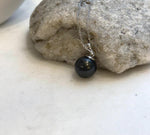 Genuine Tahitian pearl pendant featuring a deep black tone and a polished sterling silver bail.
