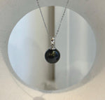 Black Tahitian ocean pearl pendant with a reflective surface and simple silver setting.