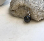Minimalist S925 sterling silver pendant showcasing a lustrous piano black Tahitian pearl.