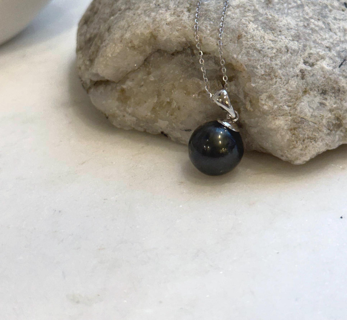 Minimalist S925 sterling silver pendant showcasing a lustrous piano black Tahitian pearl.