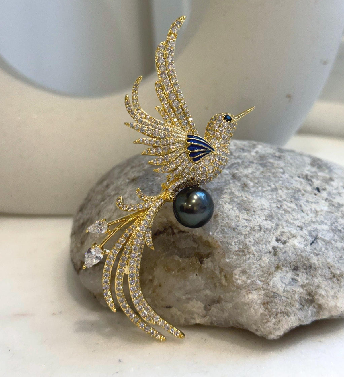Black ocean pearl featured in a bird-shaped brooch pendant, sold without a chain.