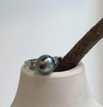 Tahitian pearl with a reflective surface in a vintage silver ring.