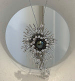 Tahitian pearl starburst pendant with a highly reflective pearl surface