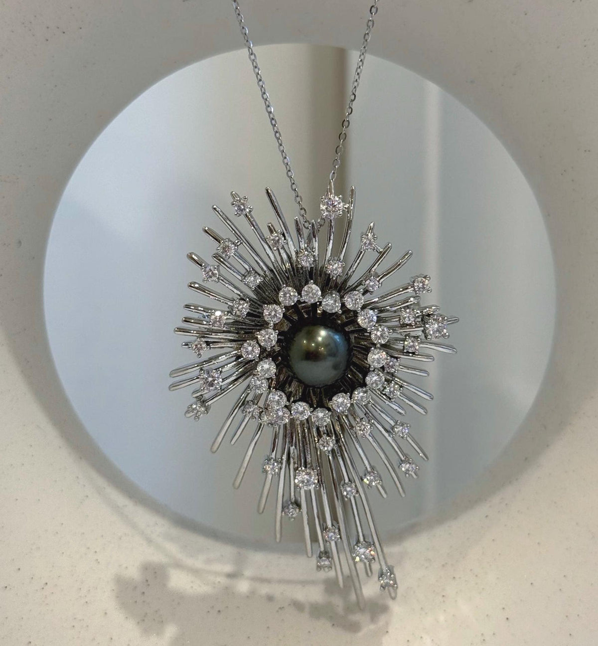 Tahitian pearl starburst pendant with a highly reflective pearl surface