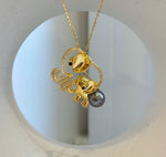 Elephant family brooch featuring an openwork design outlined with clear sparkling stones.