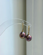 Matching pearl necklace and earrings with raspberry rose coloring and mirror luster.