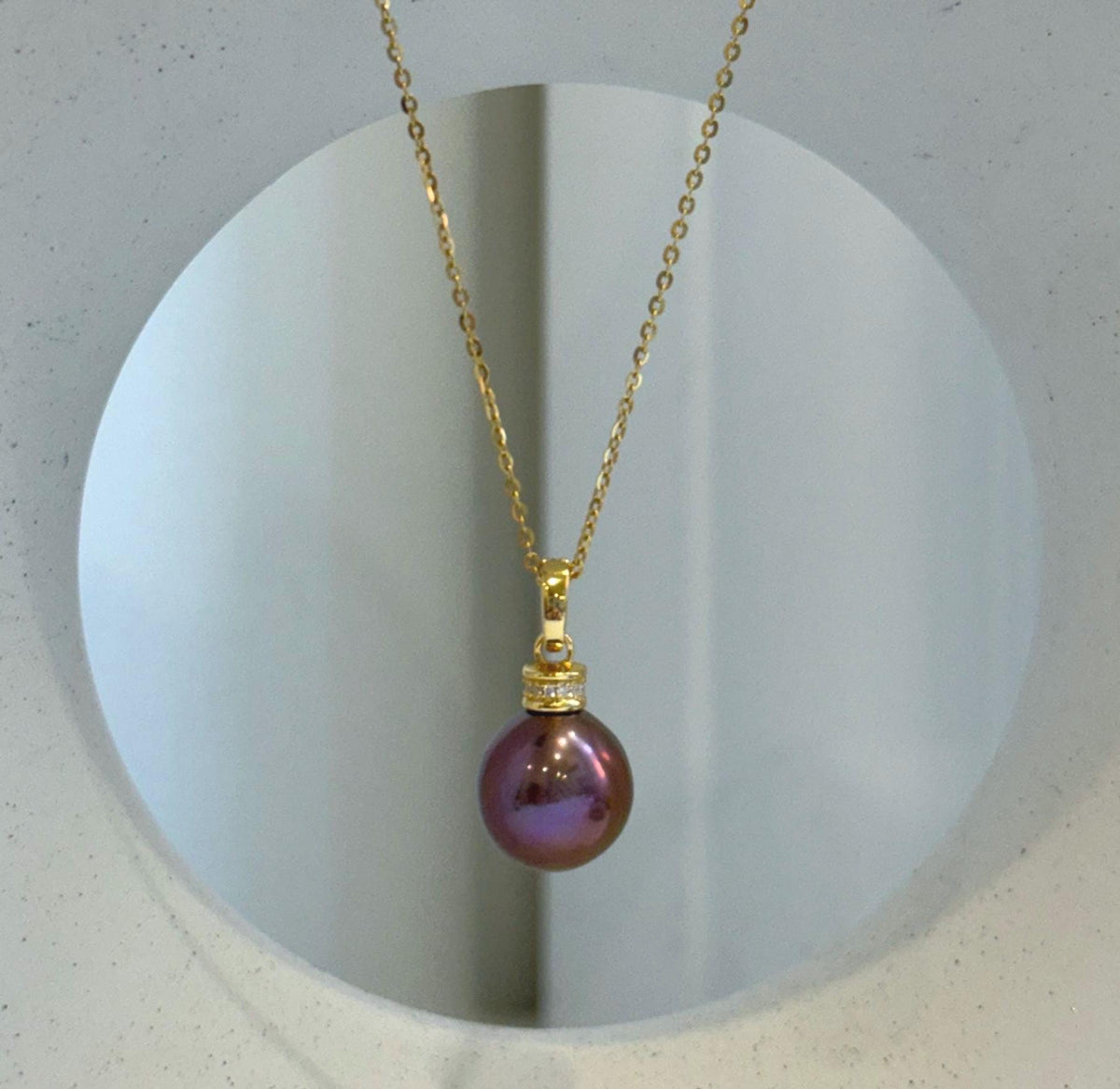 Coordinated pearl pendant necklace and earrings in a rich raspberry rose shade.