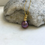 Sterling silver hook earrings paired with a matching rose raspberry pearl necklace.