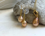 S925 sterling silver settings complement the soft peach gold tones of the pearls.