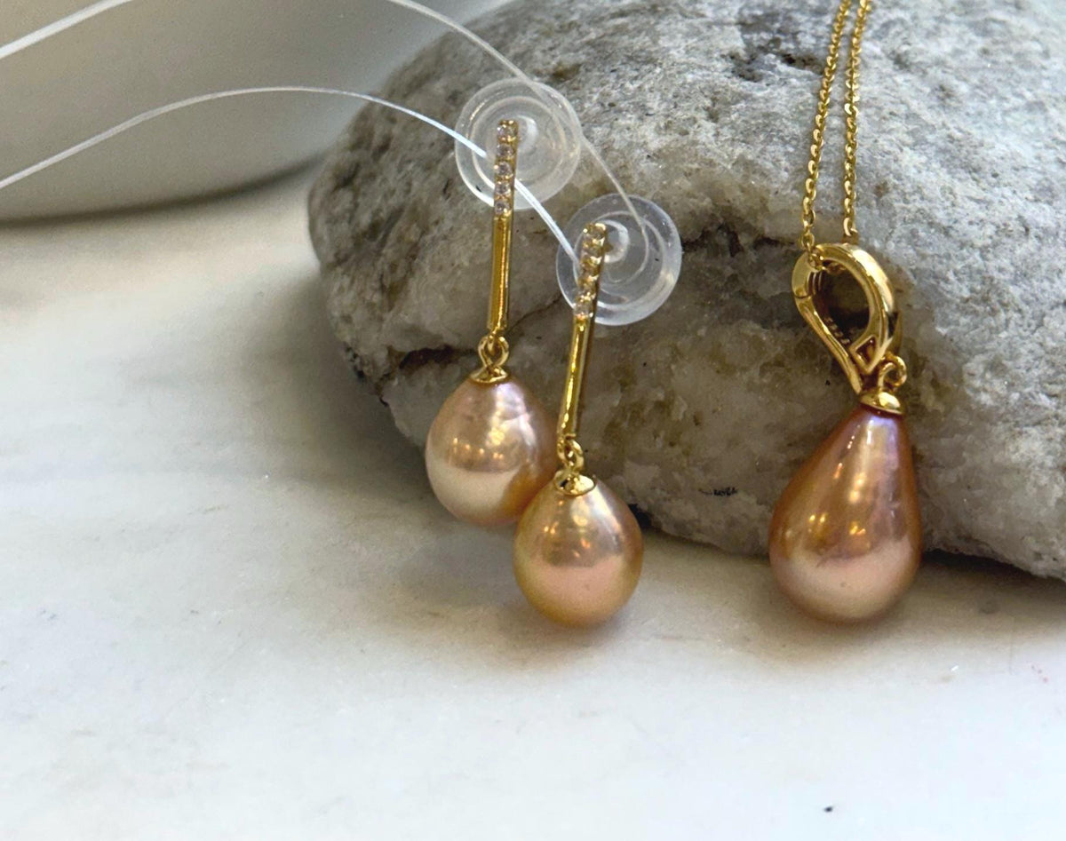 S925 sterling silver settings complement the soft peach gold tones of the pearls.