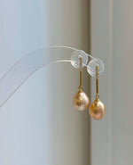 Peach gold pearls with mirror luster featured in a coordinated silver jewelry set.