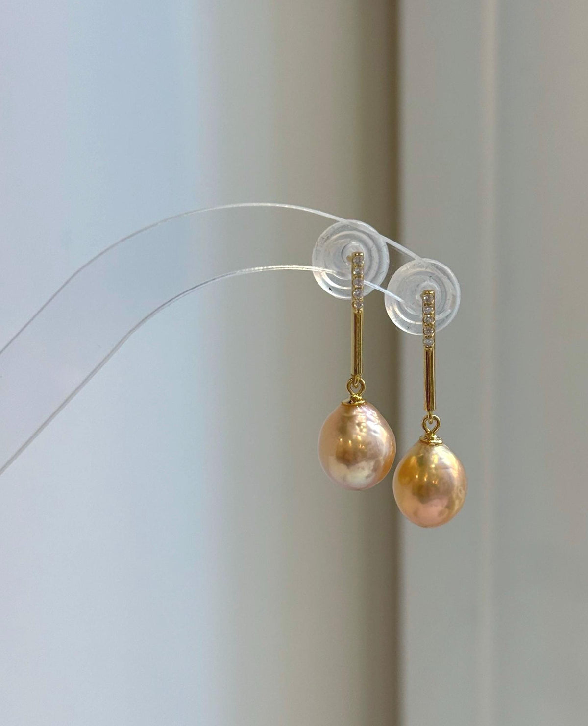 Peach gold pearls with mirror luster featured in a coordinated silver jewelry set.
