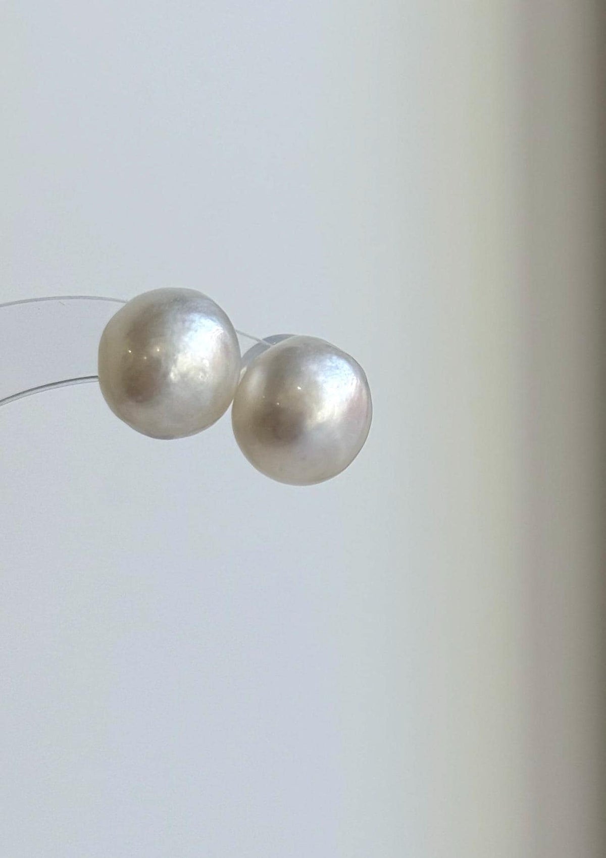 White South Sea pearl earrings with a luminous surface and minimalist sterling silver design.