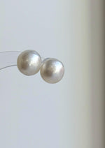 White South Sea pearl earrings with a luminous surface and minimalist sterling silver design.