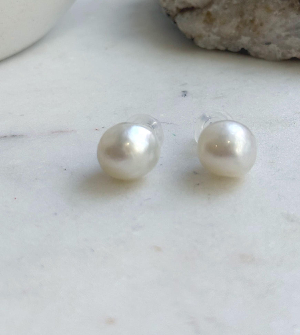 Luminous white South Sea pearls paired with S925 sterling silver stud settings.