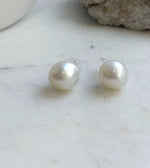 Luminous white South Sea pearls paired with S925 sterling silver stud settings.