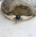 Two-in-one Tahitian pearl brooch and pendant with detailed feather wings.