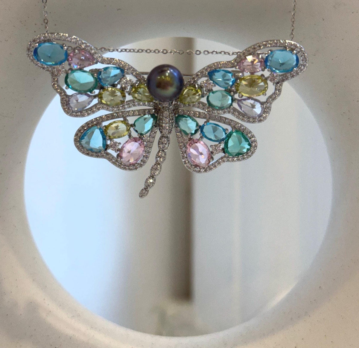 Elly’s Tahitian pearl butterfly brooch pendant with sparkling colorful wings.