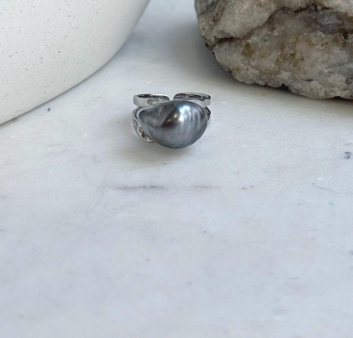 S925 sterling silver ring featuring a Tahitian keshi pearl with a reflective platinum gray surface.