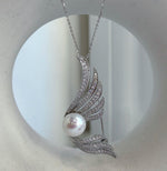 Lustrous white freshwater pearl framed by curved feather-inspired wings.