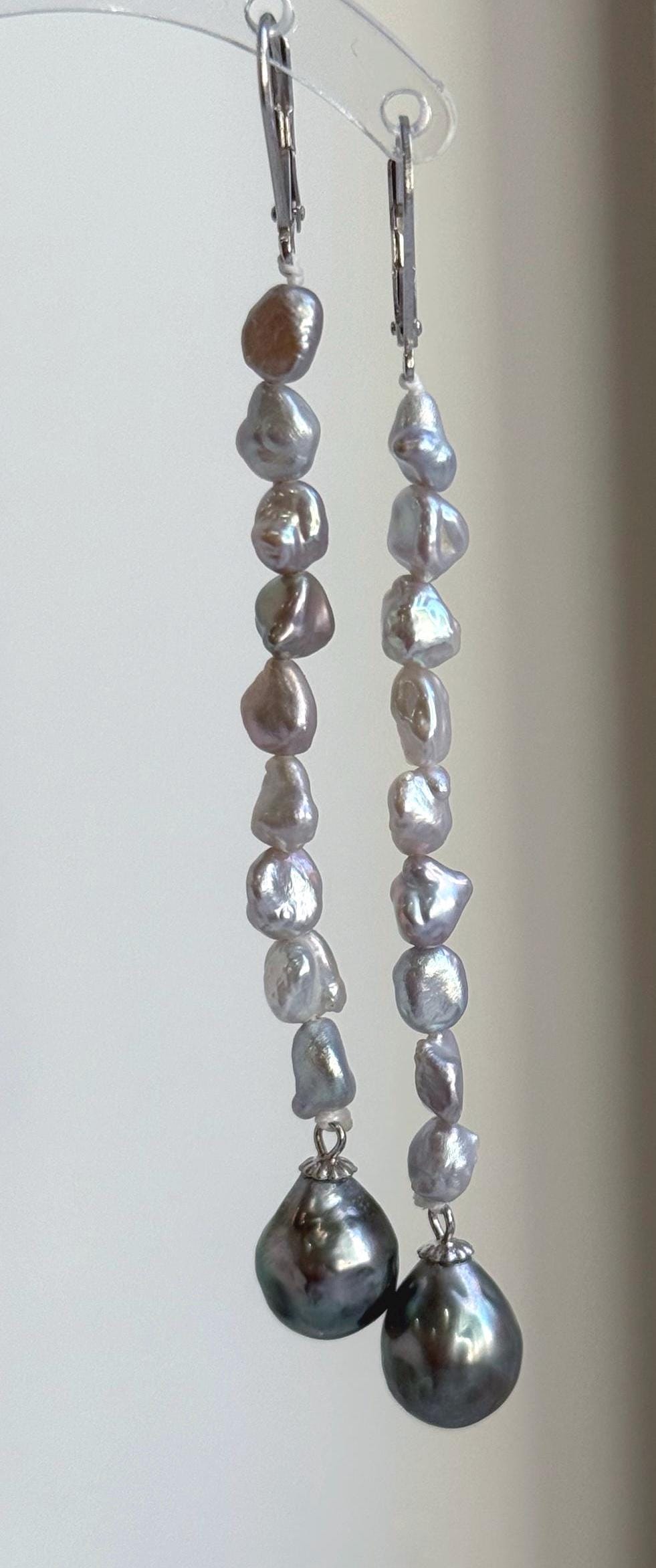 Lustrous green saltwater pearls featured in sterling silver chandelier earrings.