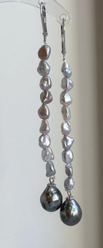 Lustrous green saltwater pearls featured in sterling silver chandelier earrings.